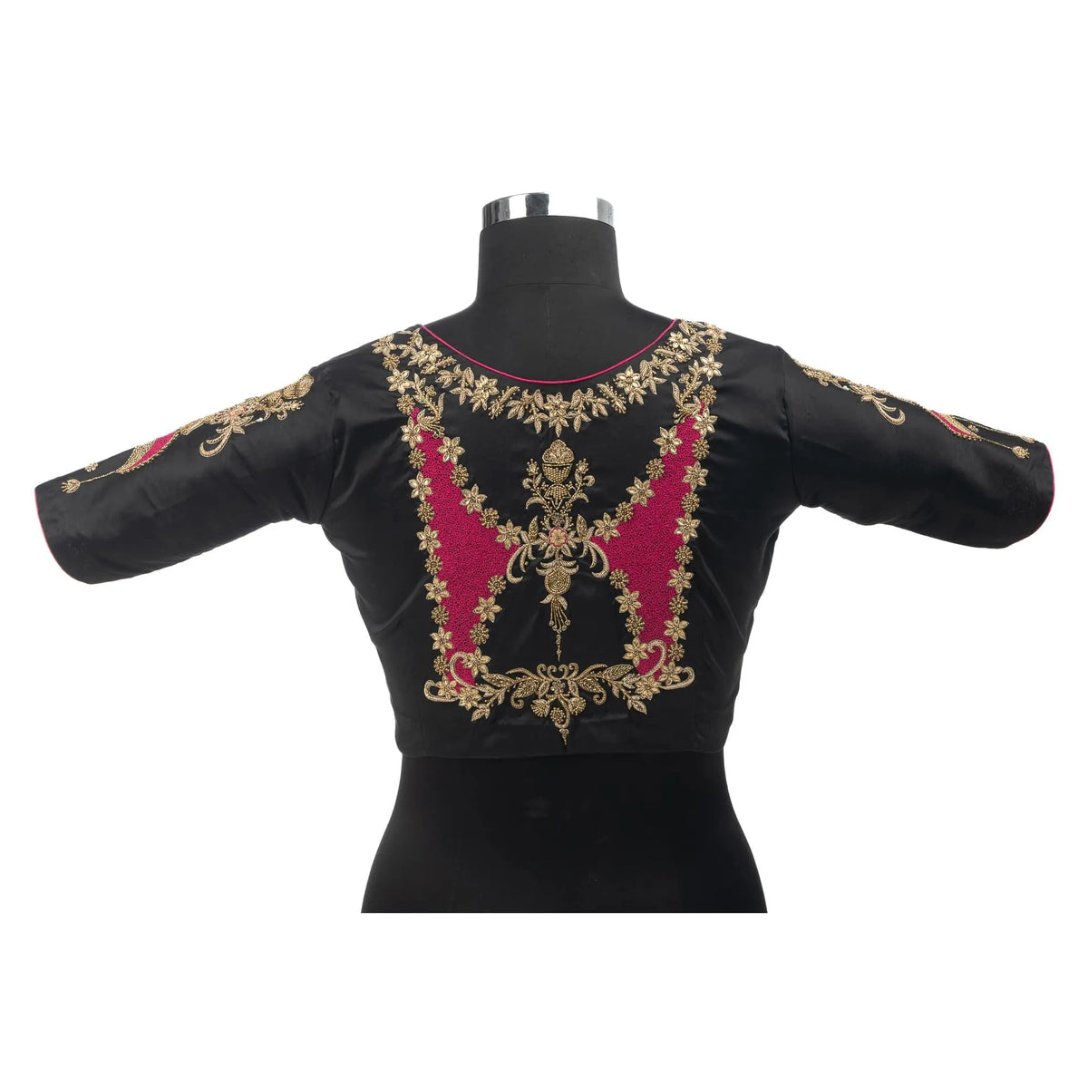 Back of the black blouse on a bust form, gold zari and pink embroidery across the yoke