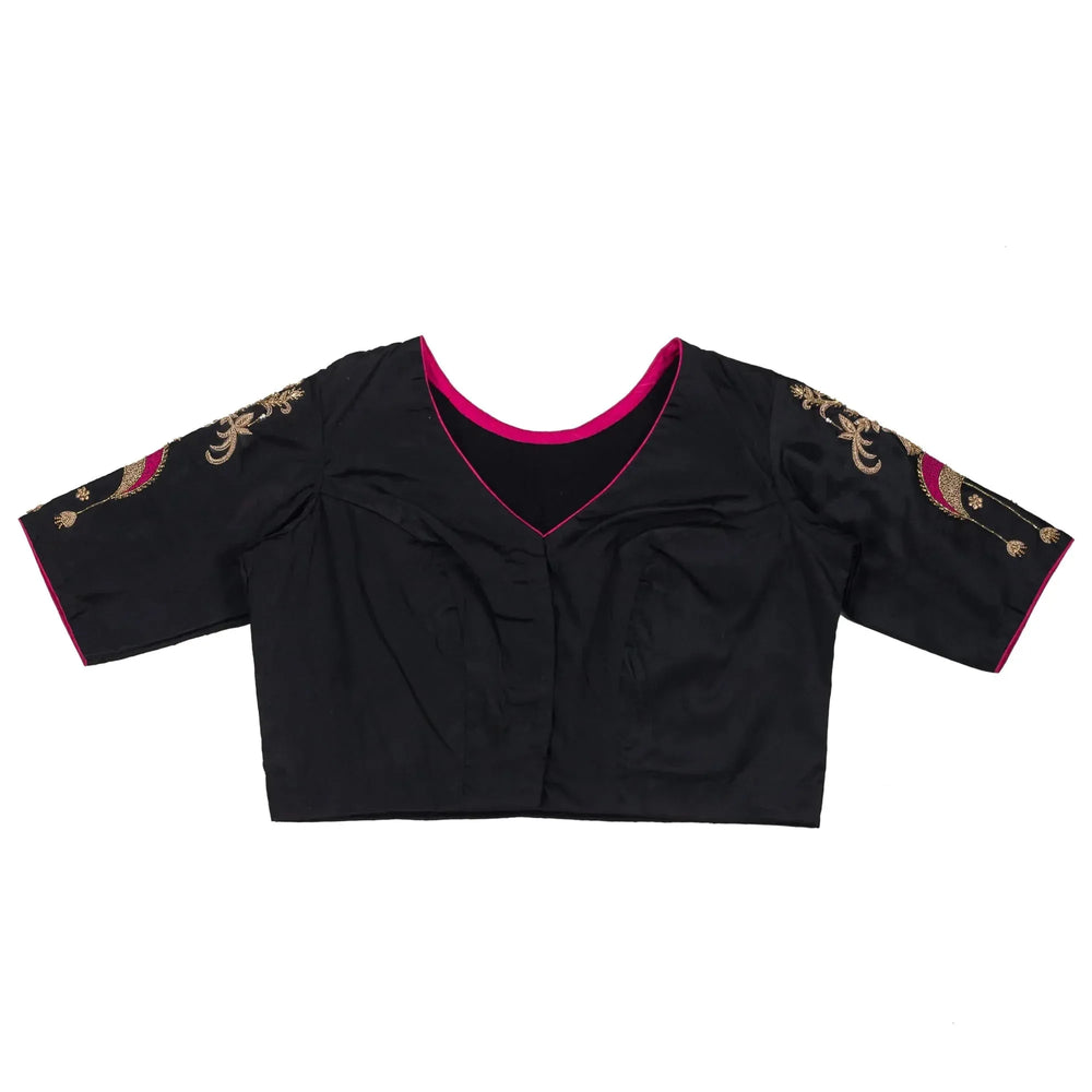 Blouse laid flat front up, pink piping at the V neck and plain black body