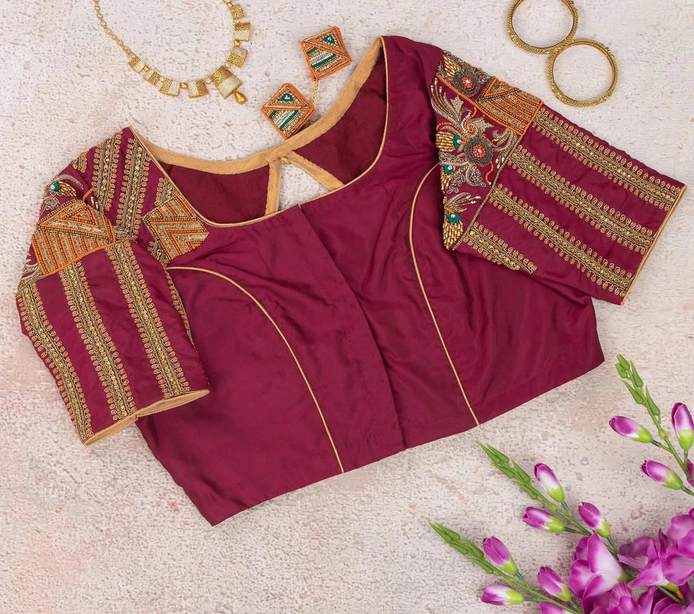 Plain maroon side with gold piping, embroidered sleeves folded out on either side