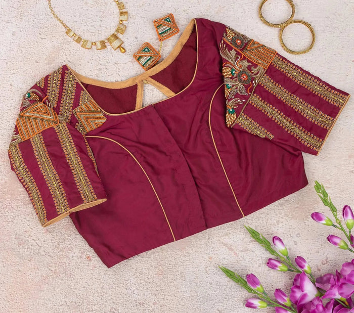 Plain maroon side with gold piping, embroidered sleeves folded out on either side