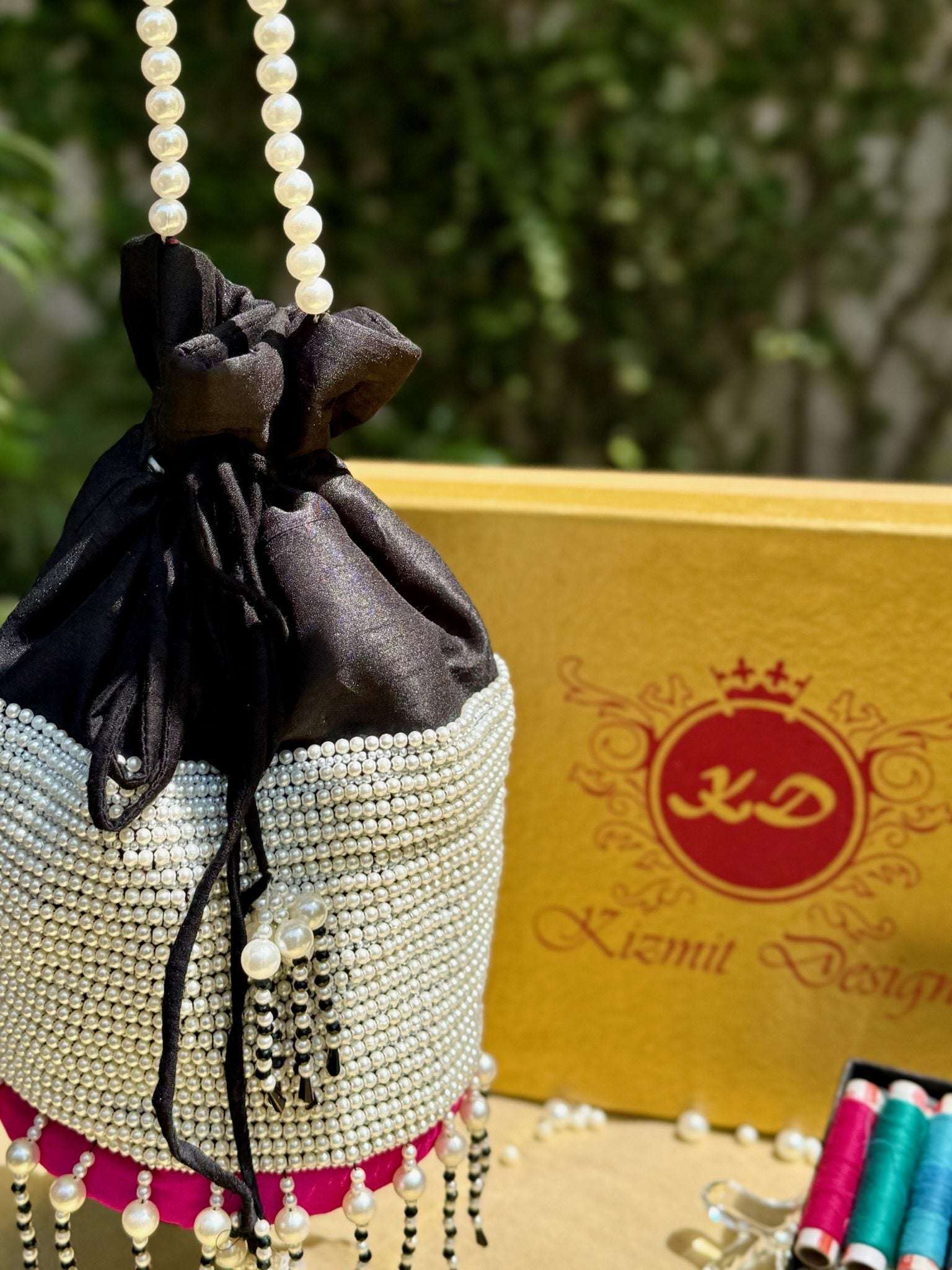 MOTI MALLIKA HAND EMBROIDERED POTLI BAG.