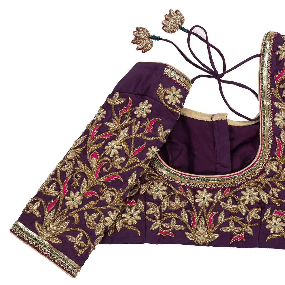 Sleeve embroidery close-up in gold and pink thread, with the dori tassels laid alongside