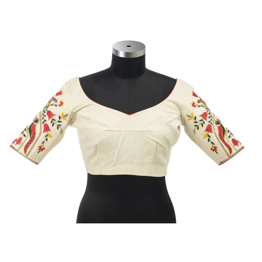 Bust form front view, sweetheart neckline edged in red with embroidered elbow-length sleeves