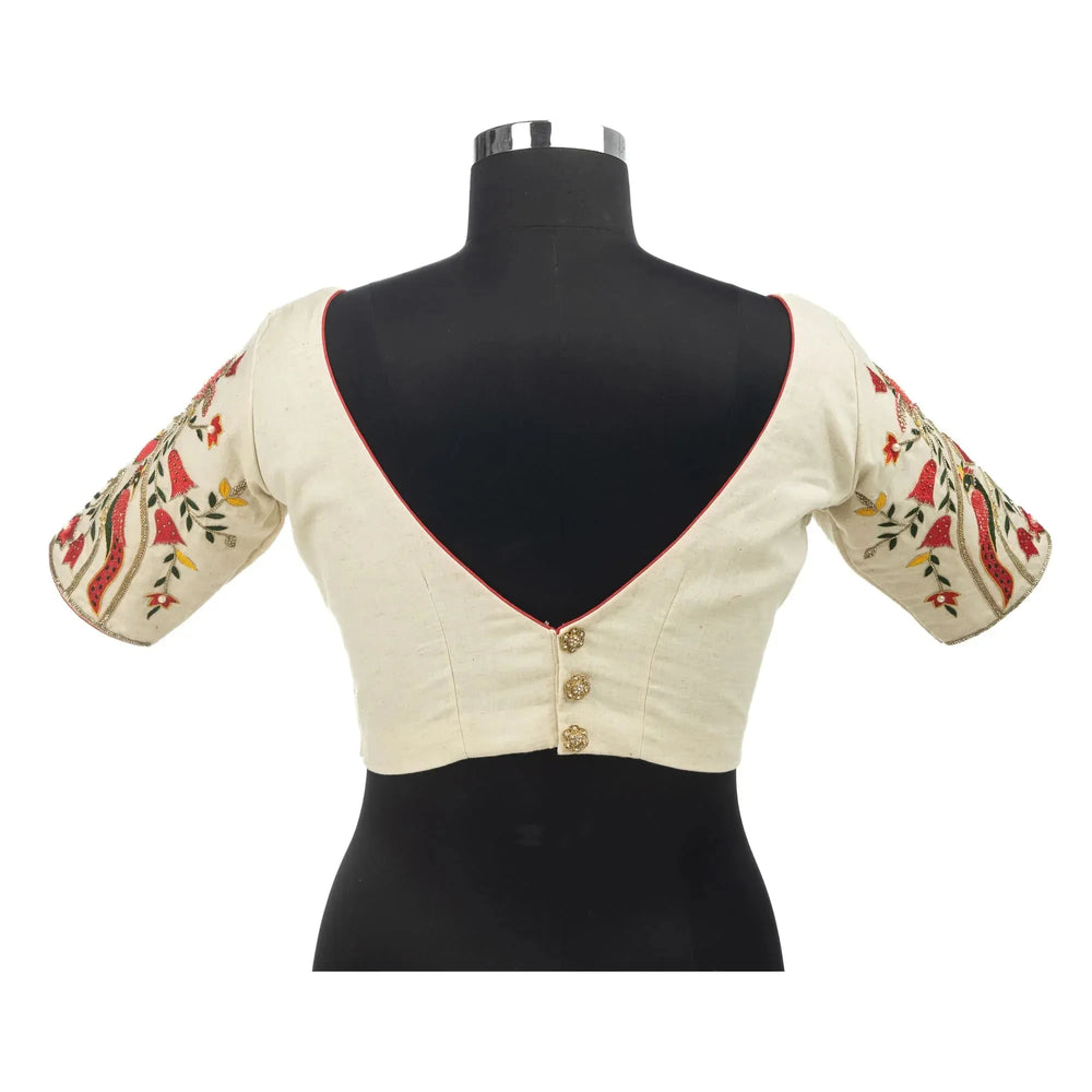 Deep V back with three buttons on a bust form, ivory blouse with embroidered sleeves