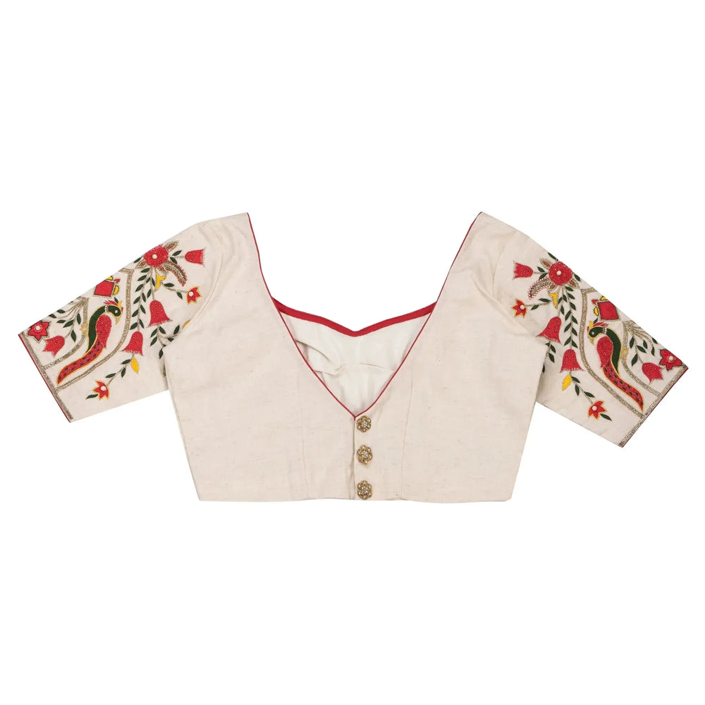 Back of the ivory blouse laid flat, V opening with three round buttons down the centre
