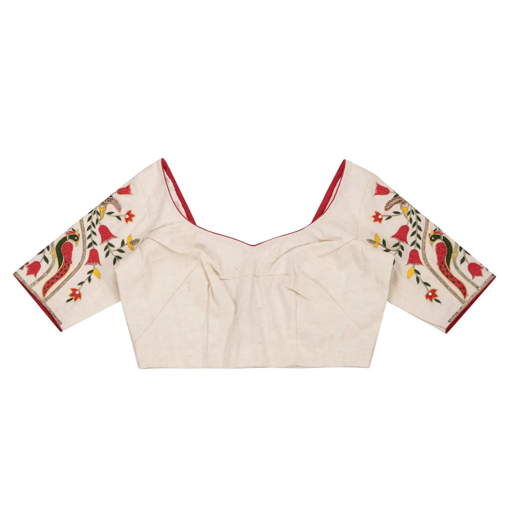 Ivory blouse laid flat front up, sweetheart neckline and mayur motif sleeves