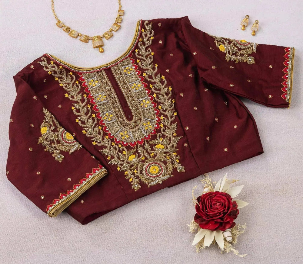 Maroon blouse styled flat with a jewellery set, zardozi panel and floral sleeve motifs