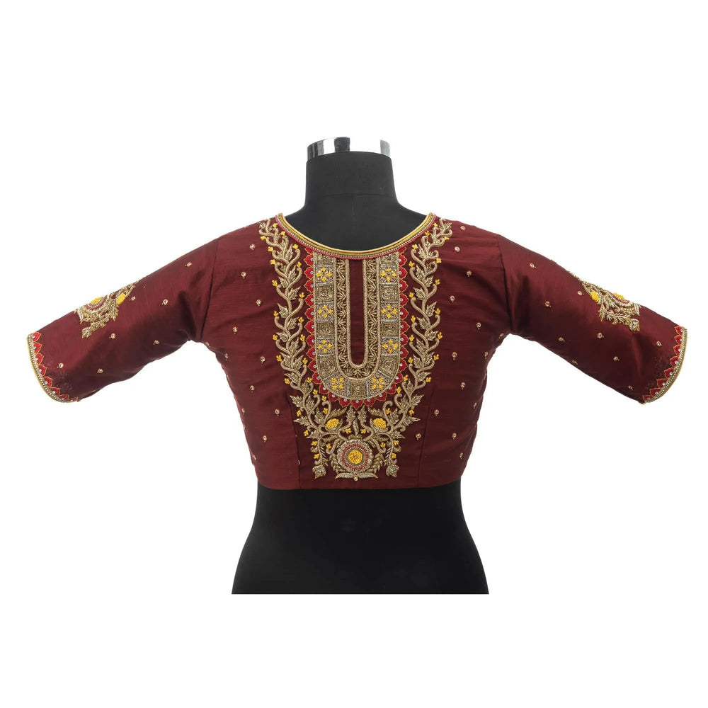 Embroidered maroon blouse on a bust form, gold zardozi panel running down the centre