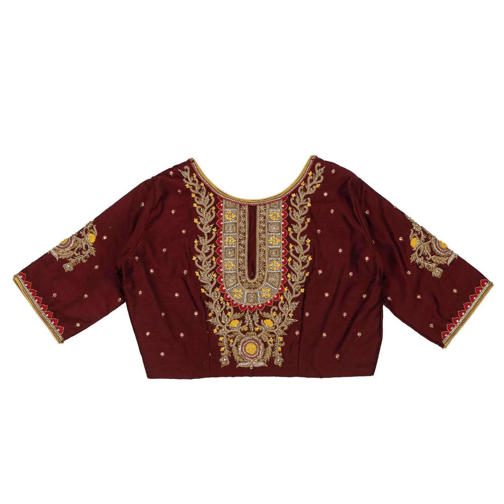 Maroon blouse laid flat showing the full zardozi panel and scattered gold bootis