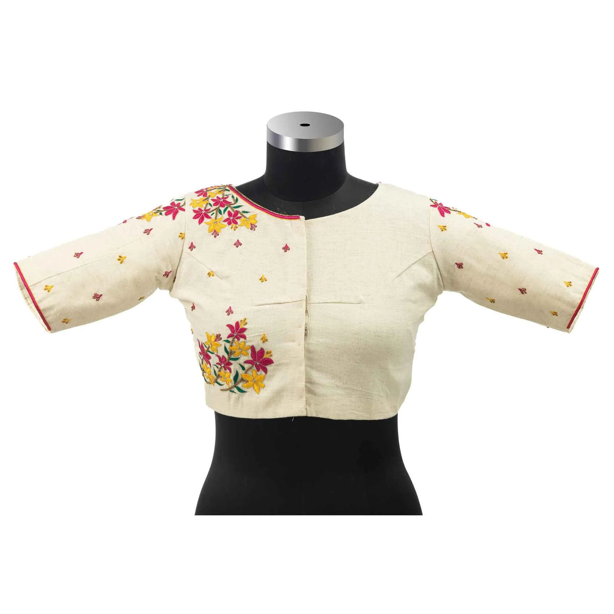 Front view on a bust form showing the hook placket and red piping at the sleeve edge