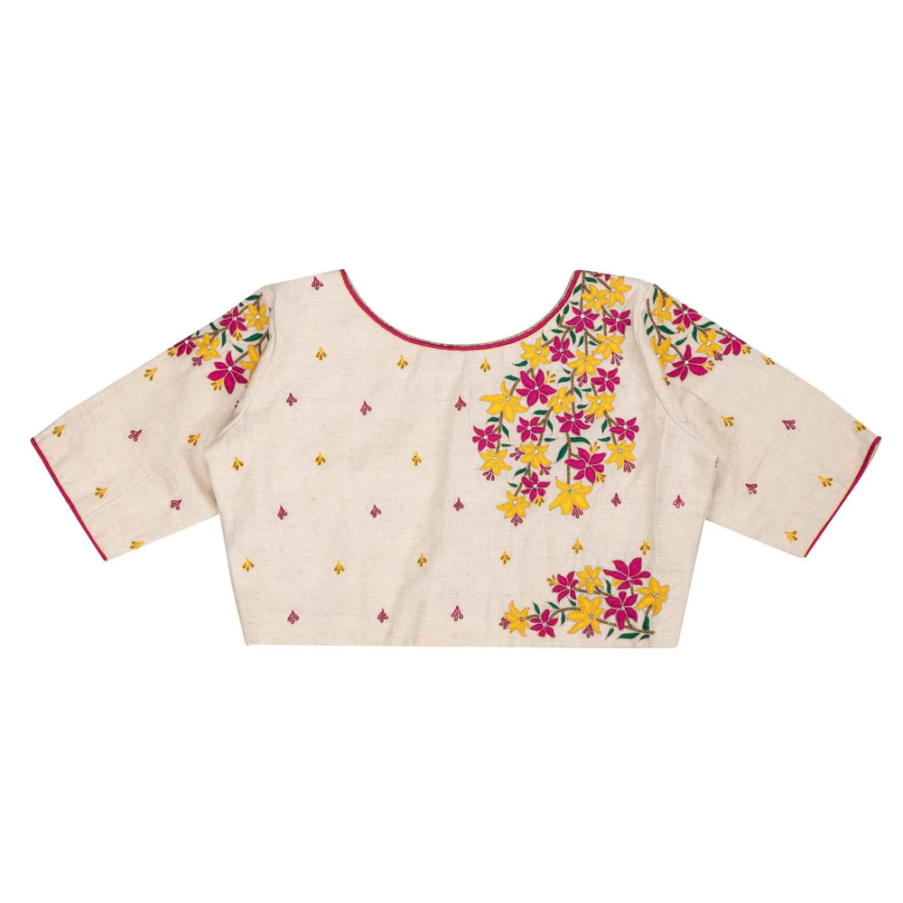 Flat back view, round neckline piped in red with embroidered flowers below