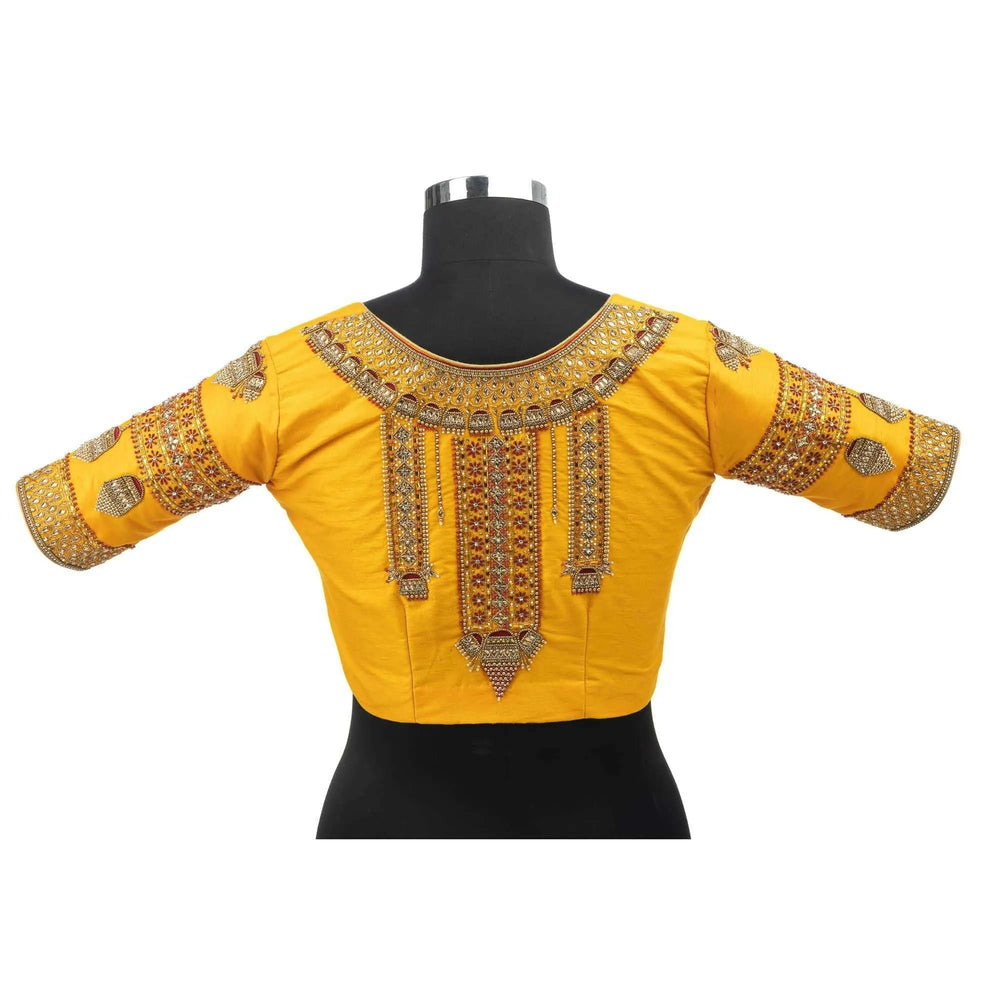 Back on a bust form, jhumka motifs and mirror work running down the yoke