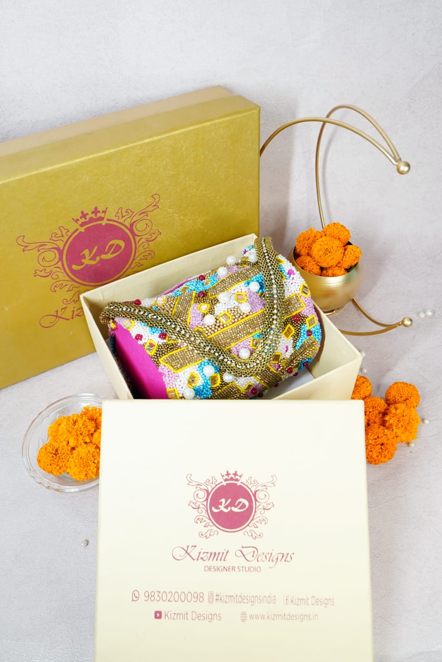 Mosaic beaded bag packed in its Kizmit Designs gift box with marigolds alongside