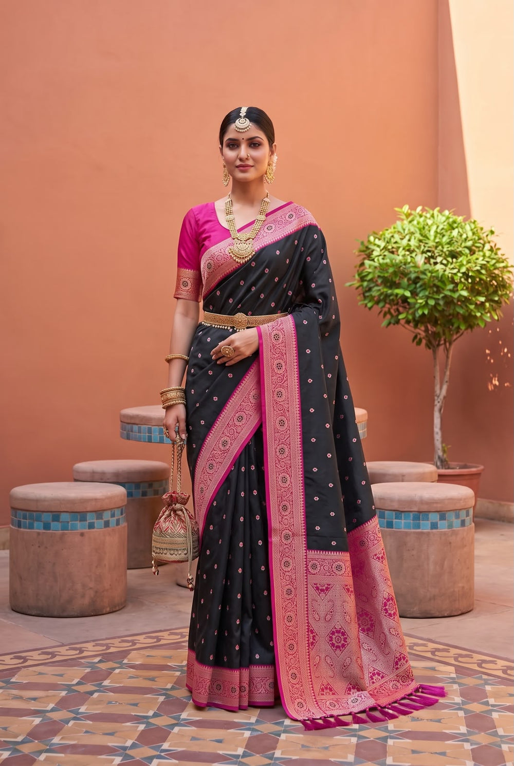 Model wearing the black Banarasi Paithani saree with rani pink contrast border