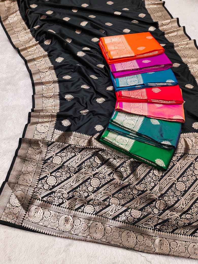 The eight colourways of the Banarasi soft silk saree shown together, black laid out with the rest folded alongside