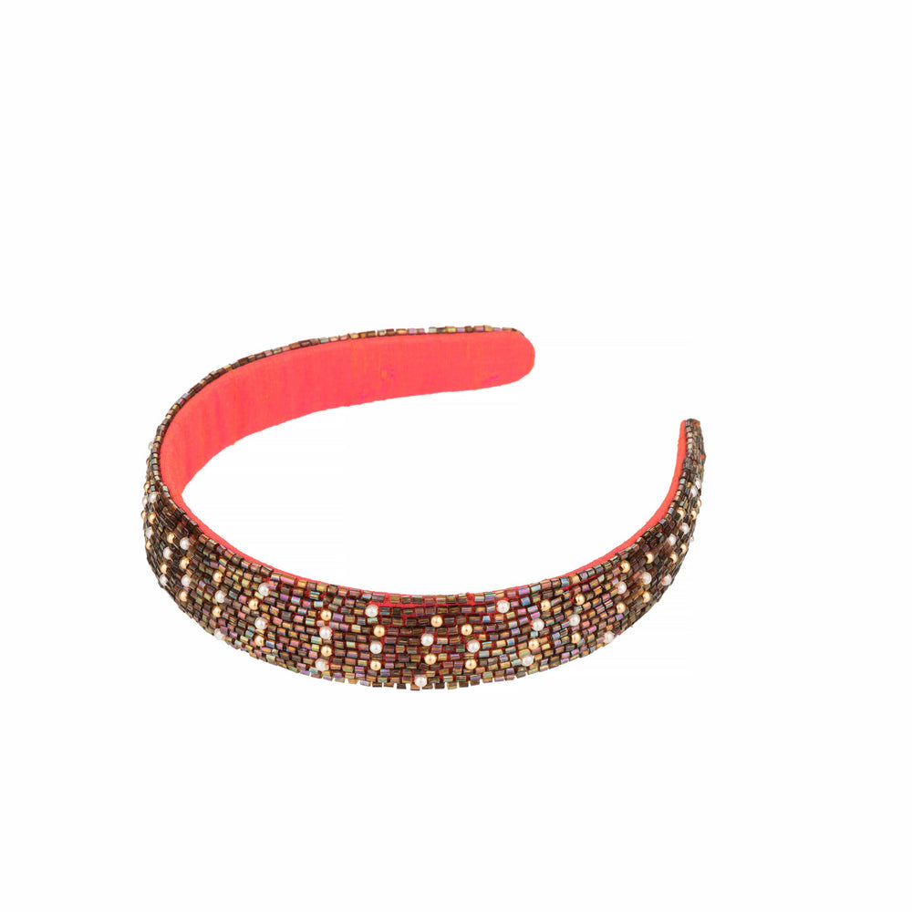 Hand-embroidered bronze bead hairband on white, coral fabric lining visible inside