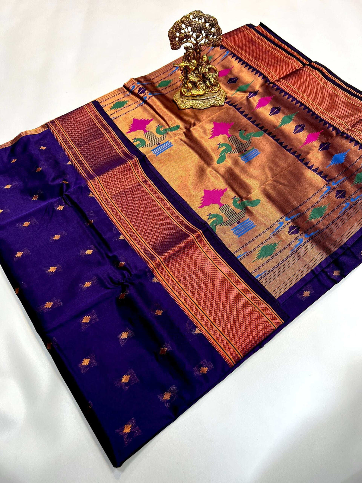 Deep indigo Paithani saree with copper-gold pallu and coloured peacock motifs