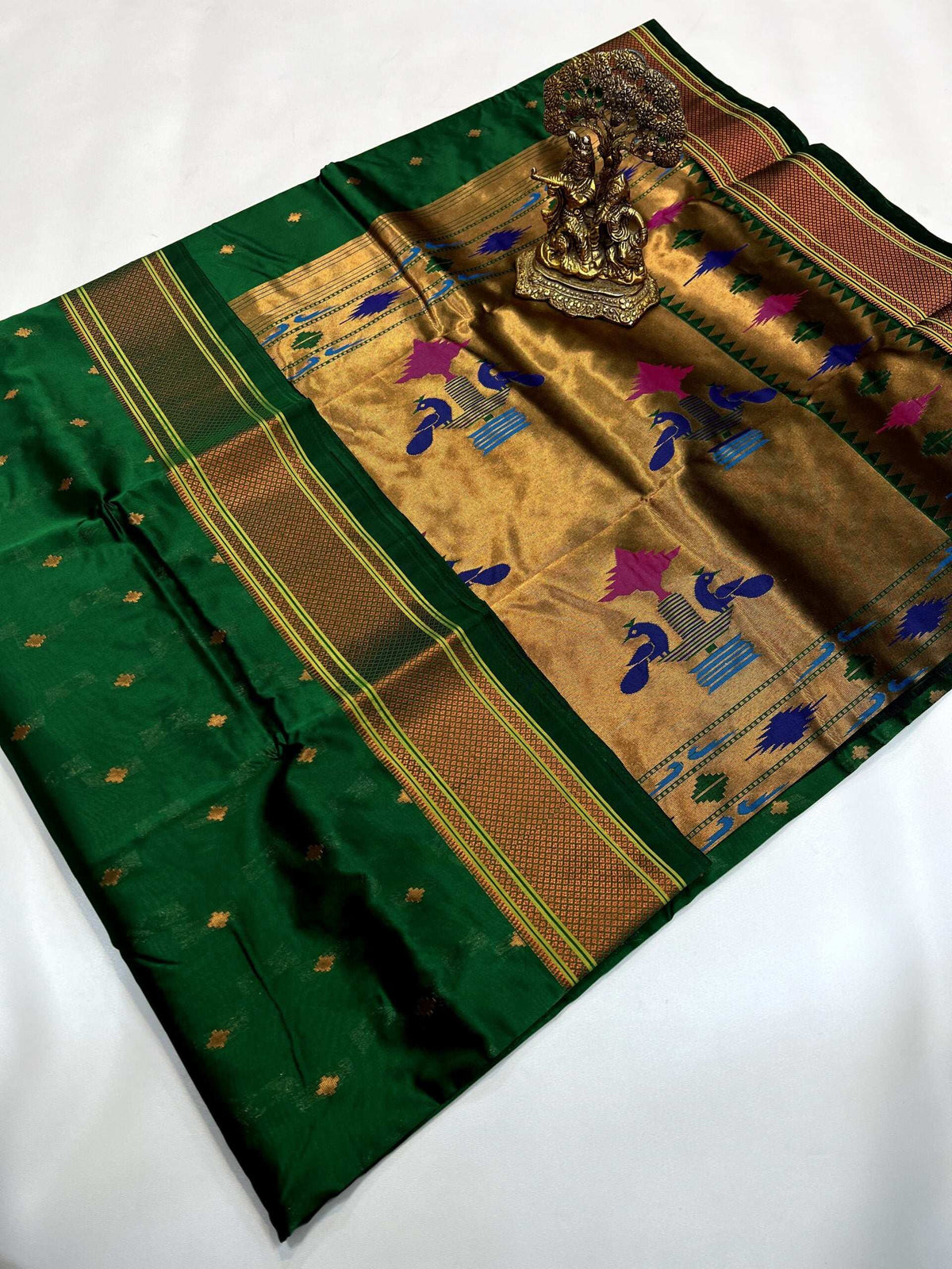 Bottle green Paithani saree with gold pallu, peacock motifs in pink and blue