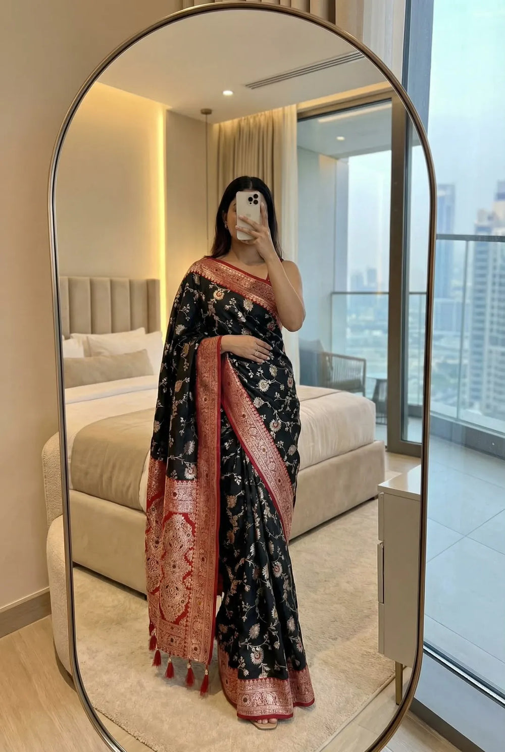 Black soft silk saree with red designer border, draped with the brocade pallu falling in front