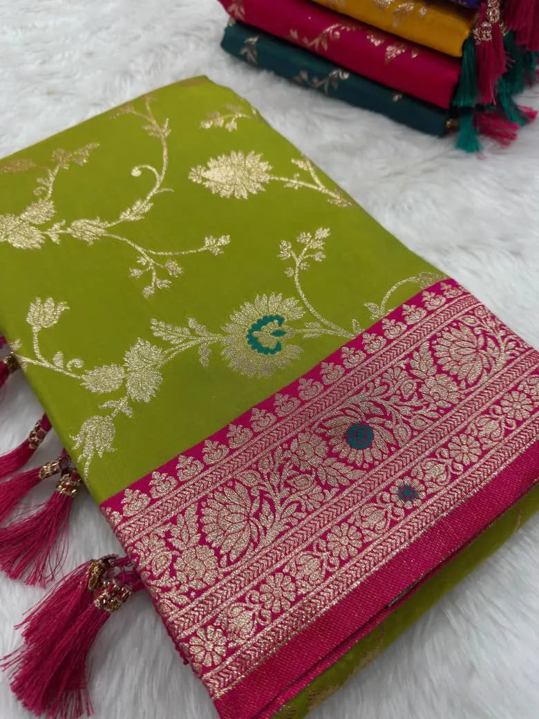 Mehendi green saree folded flat with gold zari jaal and a rani pink brocade border
