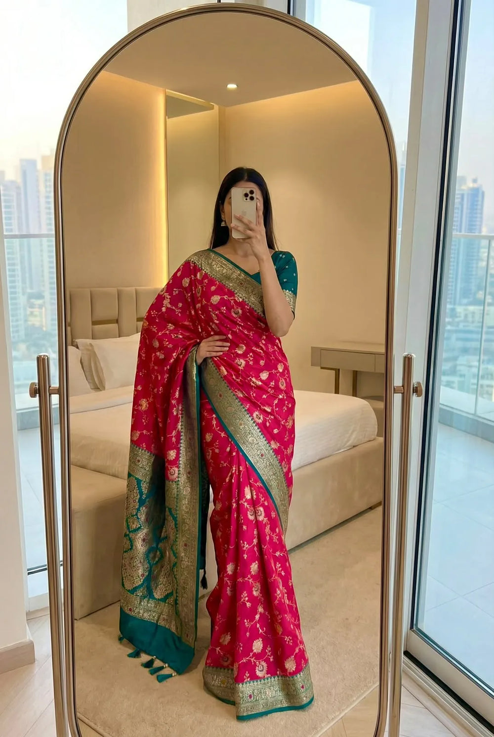 Rani pink soft silk saree with teal contrast border, worn with a matching teal blouse