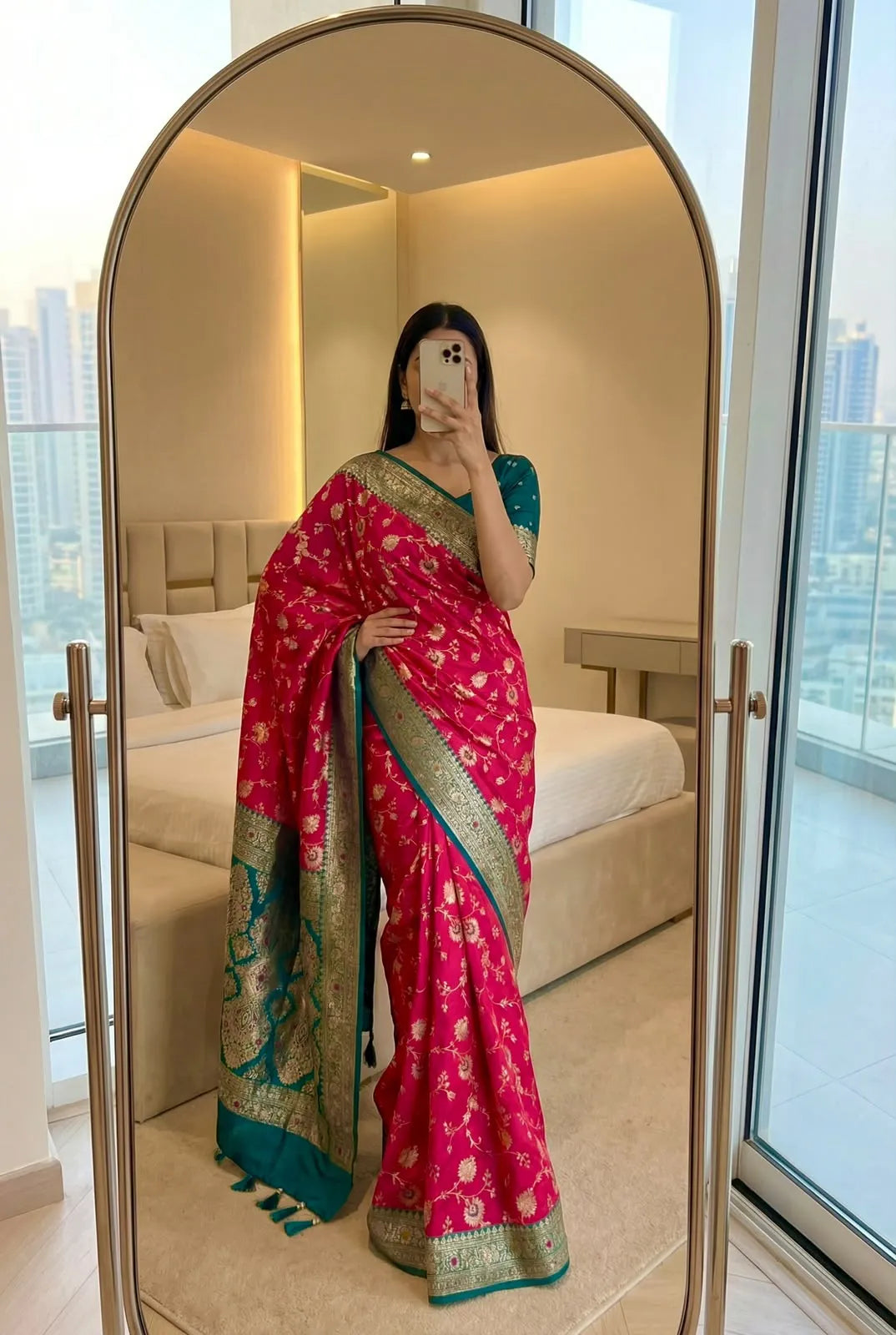 Rani pink soft silk saree with teal contrast border, worn with a matching teal blouse