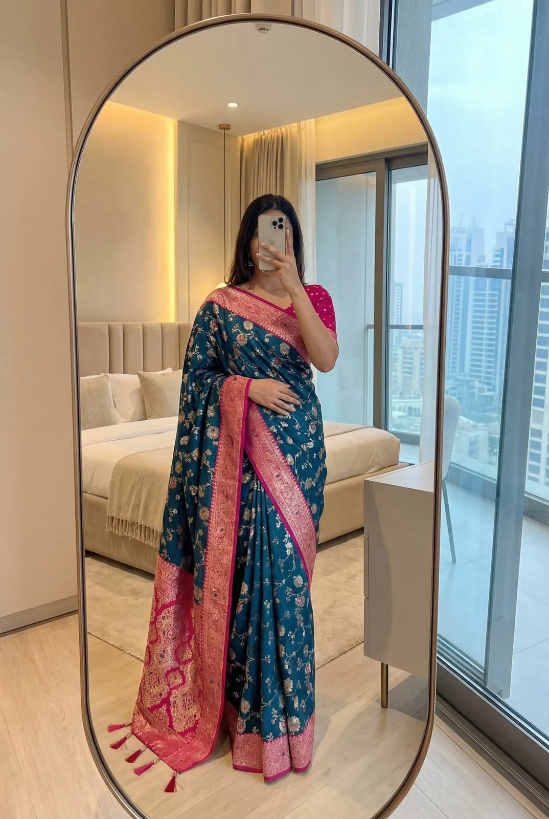 Peacock teal soft silk saree with rani pink border, worn with a pink blouse