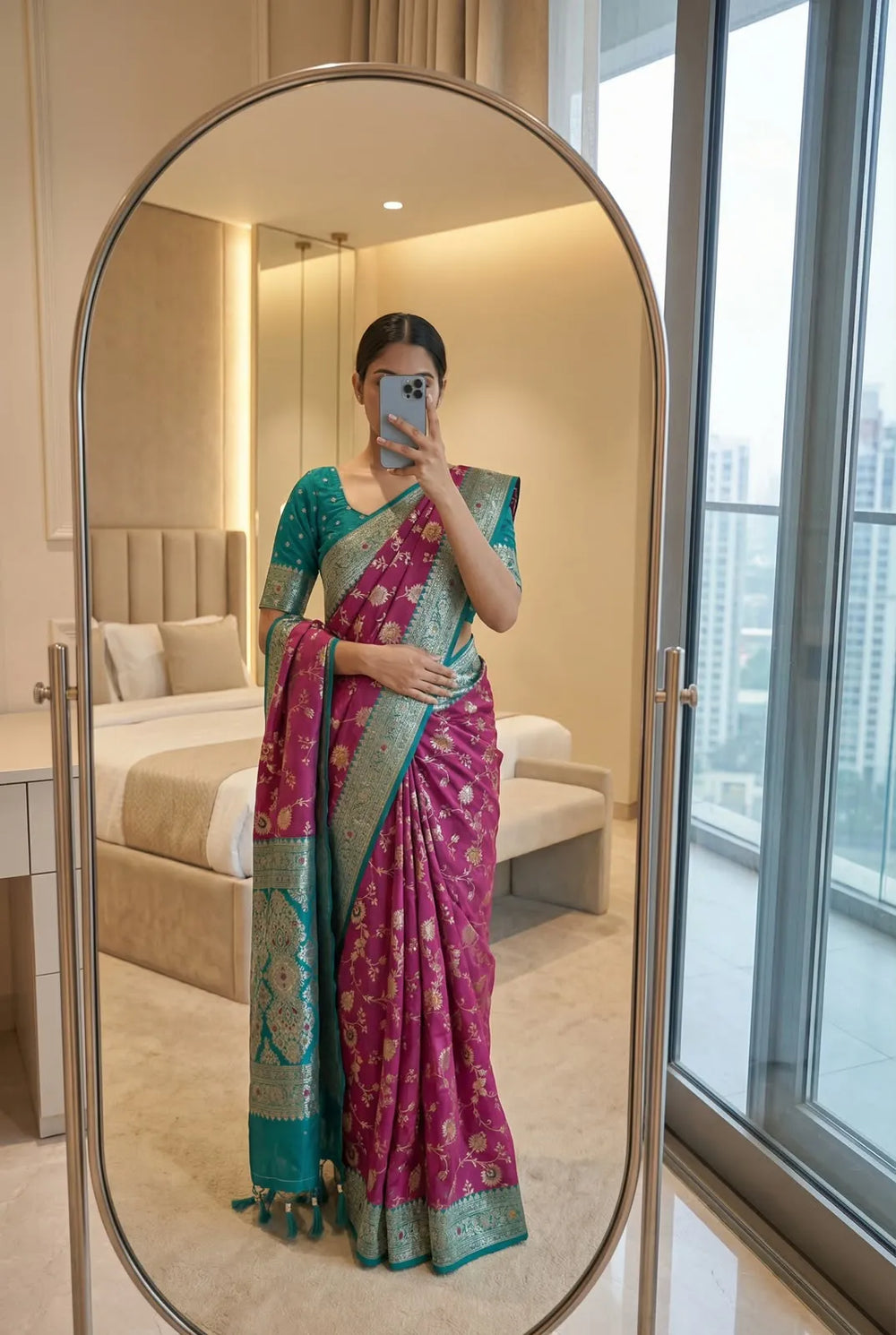 Wine pink soft silk saree with teal border, worn with a matching teal blouse