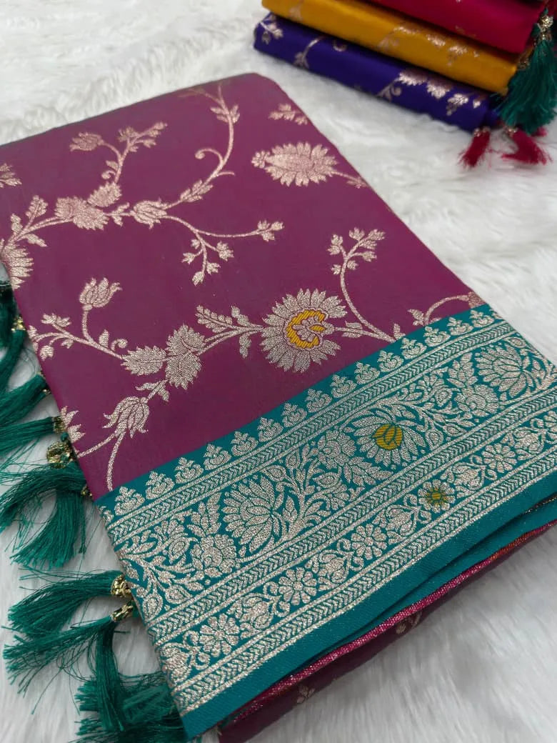 Wine pink saree folded flat, rose-gold zari jaal beside a teal brocade border