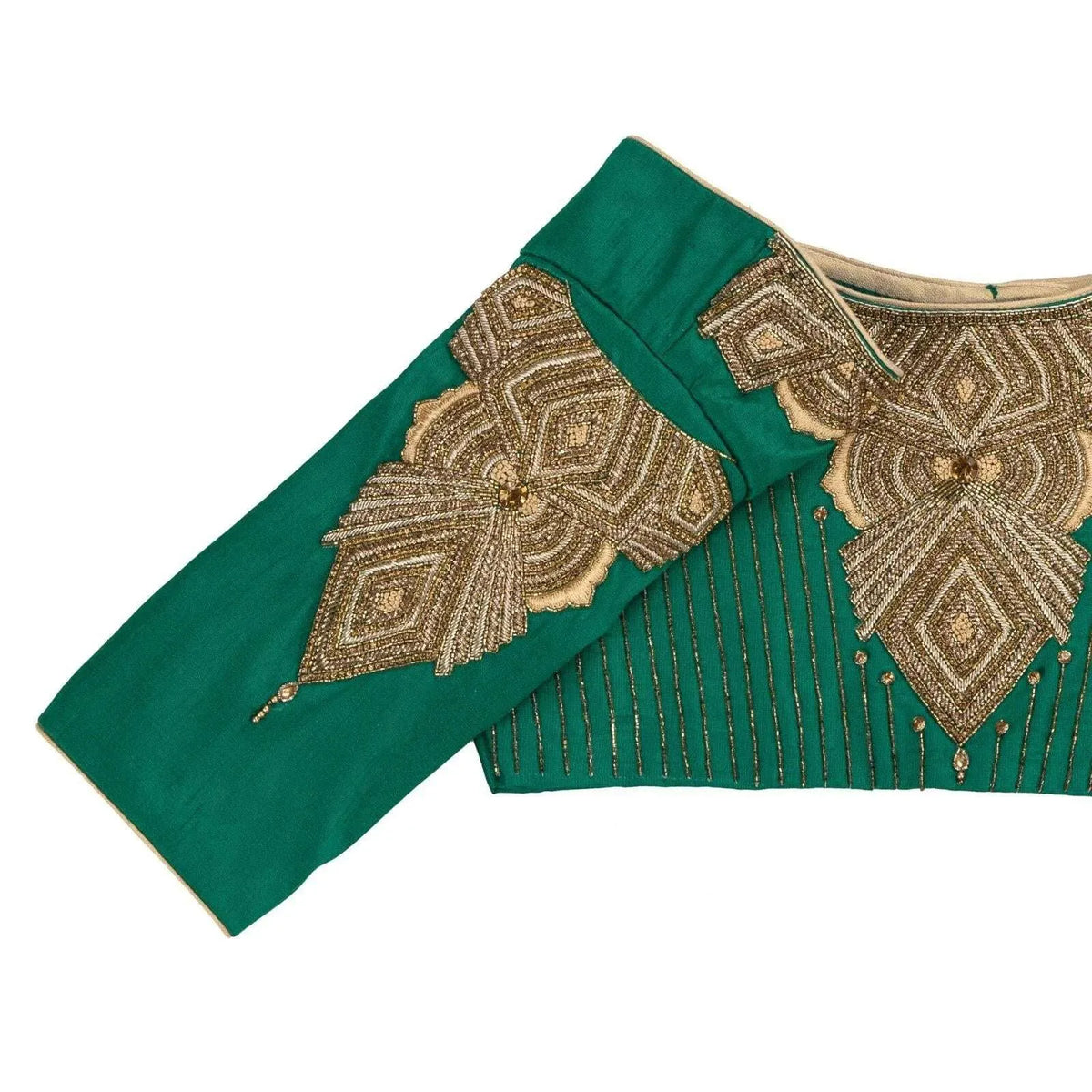 Close-up of gold geometric embroidery on the shoulder and sleeve cap