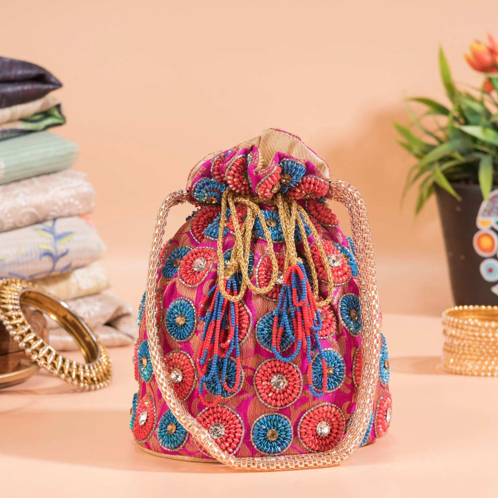Gathered drawstring top of the spiral-motif potli with beaded cords and tassels