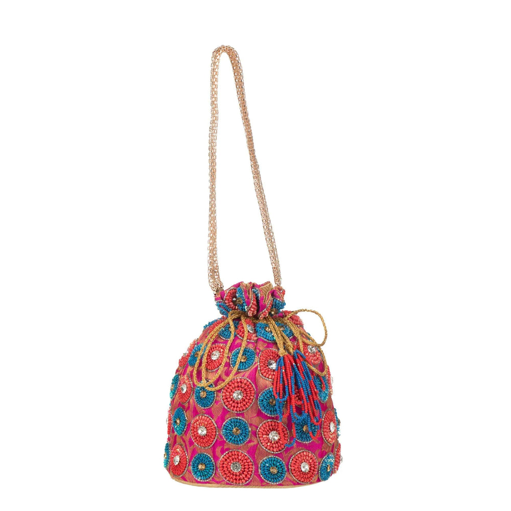 Spiral beaded potli bag hanging from its long gold cord on a white background