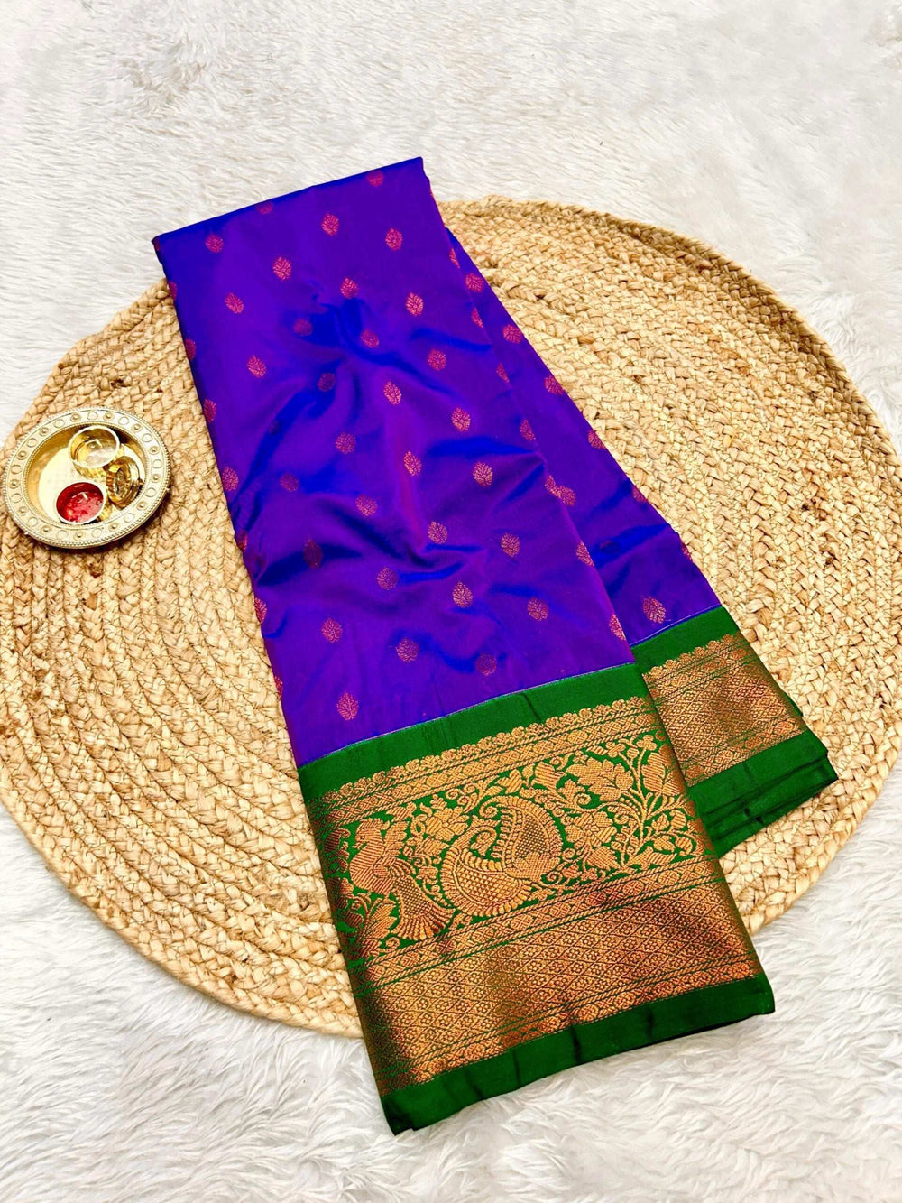 Violet blue body with copper bootis, green peacock brocade border on Gadwal Paithani