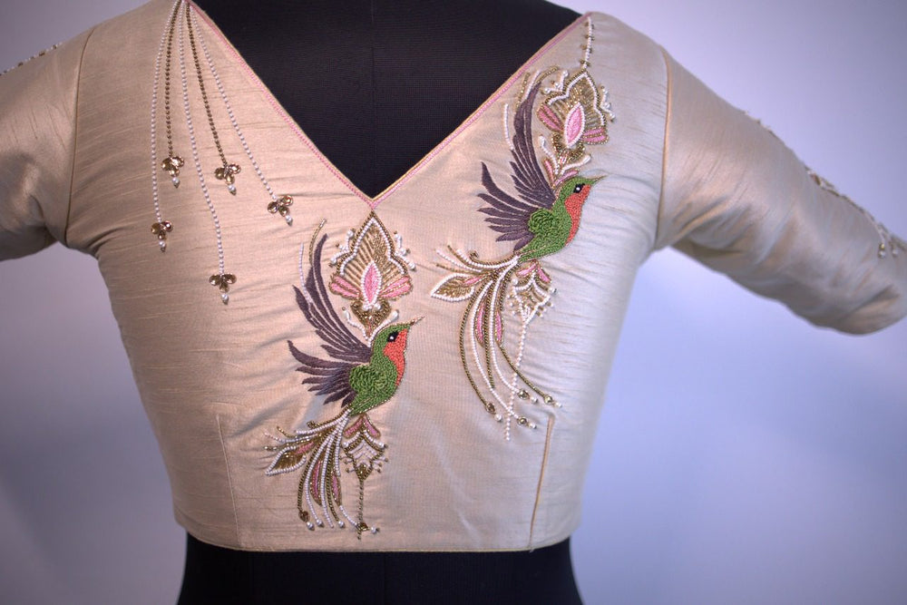 Front view on a bust form, two embroidered birds flanking the V neck with zari drops