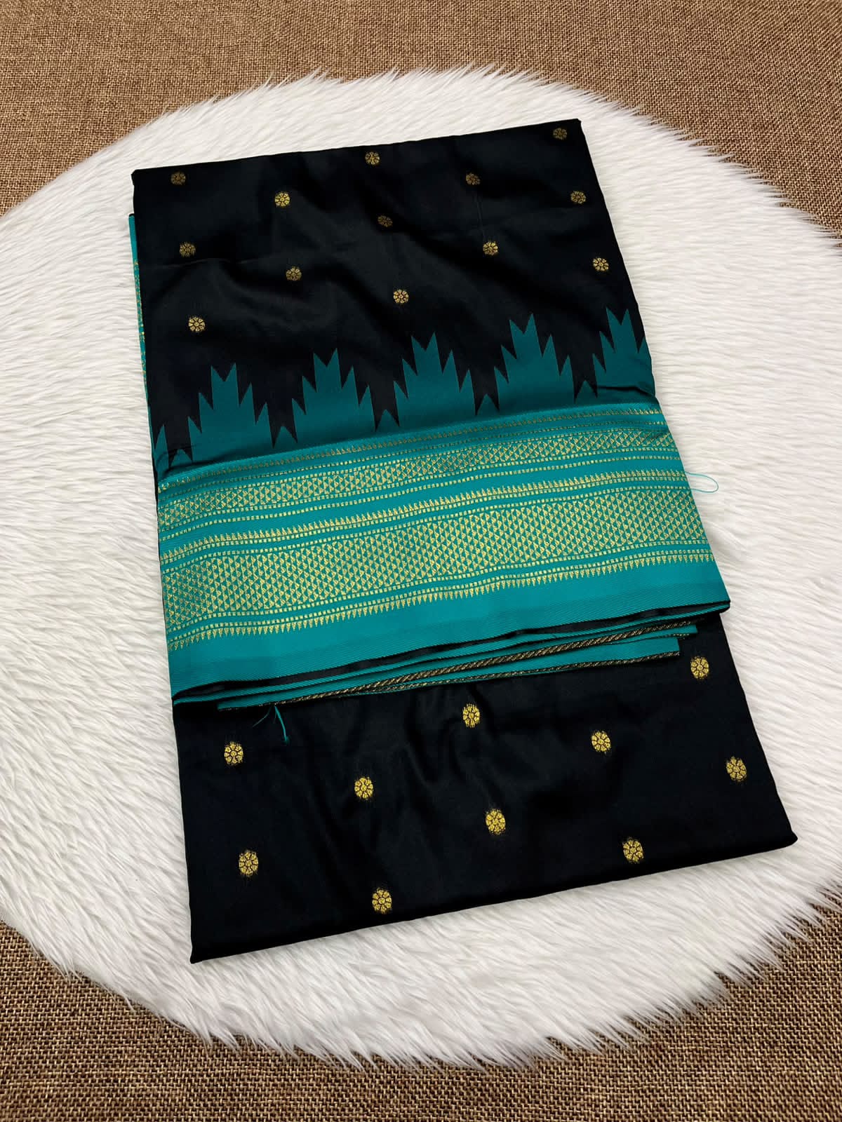 Ilkal silk saree in black with a teal temple border and gold buttis