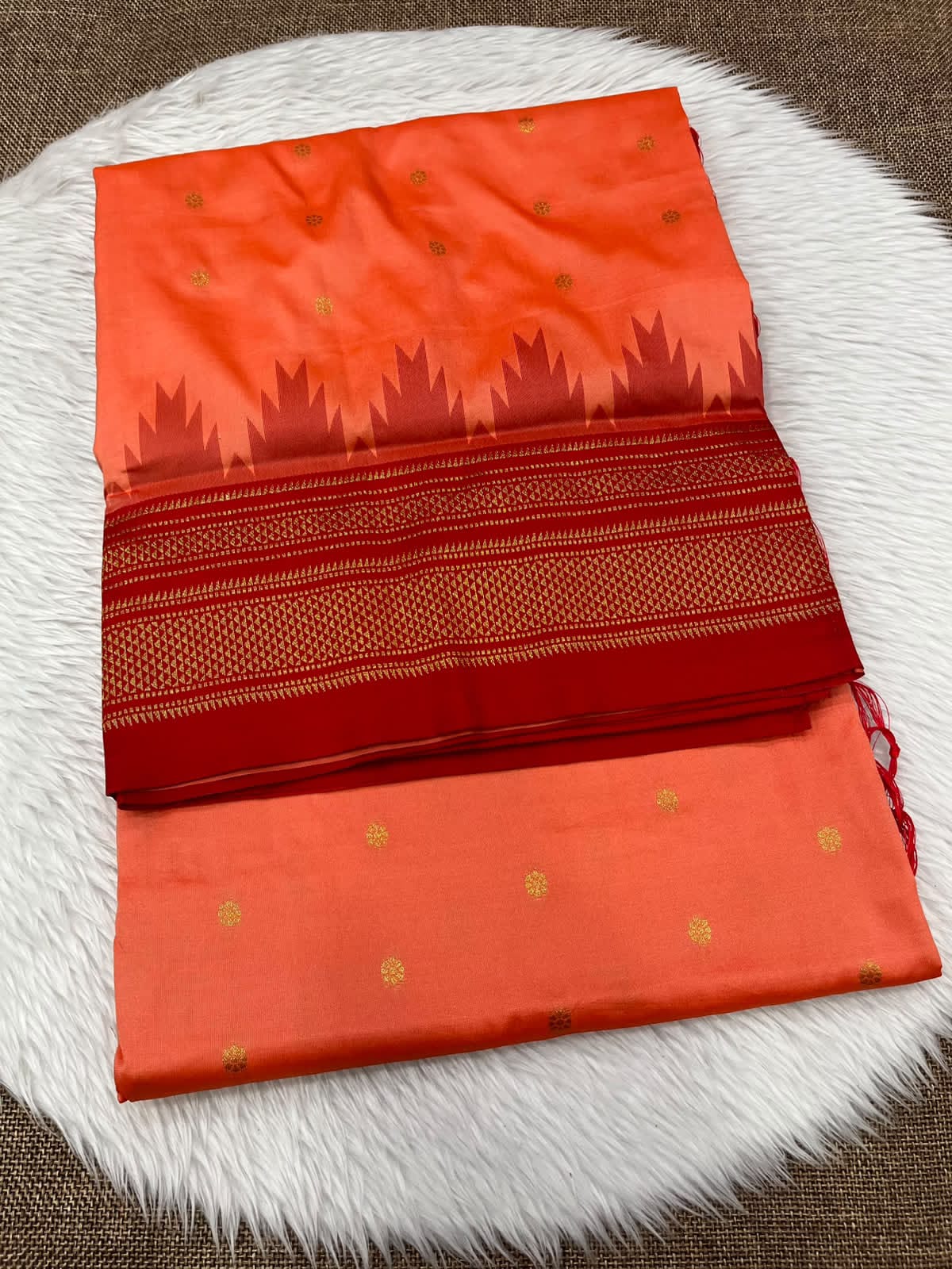 Ilkal silk saree in coral orange with a red temple border and gold buttis