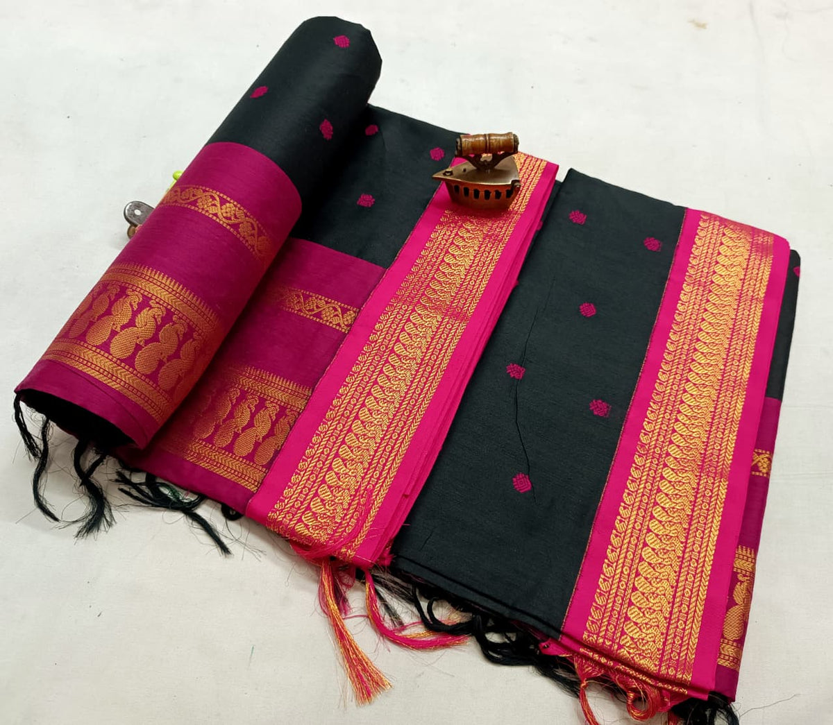 Black Gadwal saree with rani pink and gold zari border and pink bootis over the body
