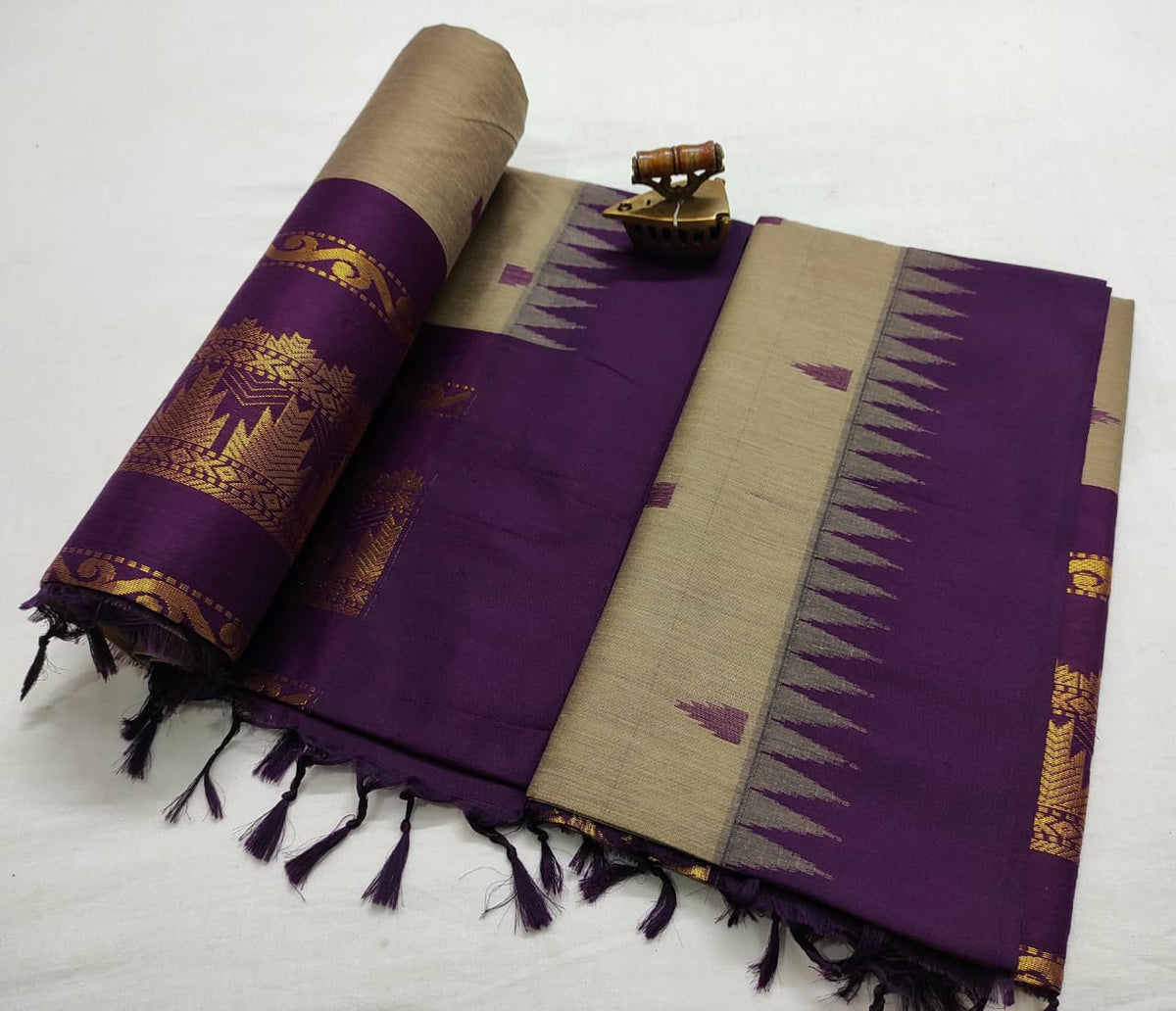 Beige Gadwal saree with purple temple-tip border and zari motifs on the rolled pallu