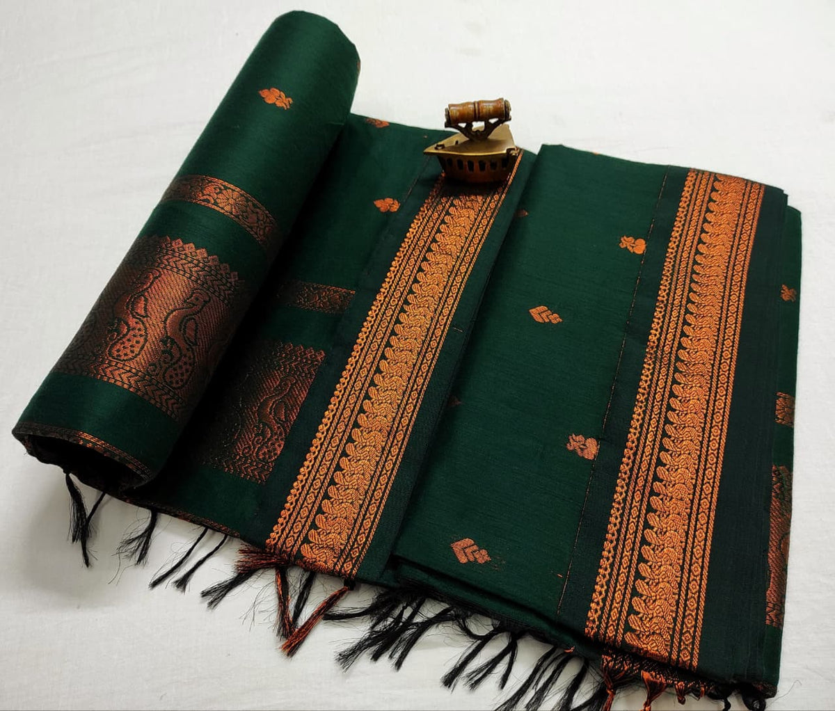 Bottle green Gadwal saree with copper zari bootis and a matching tone-on-tone border