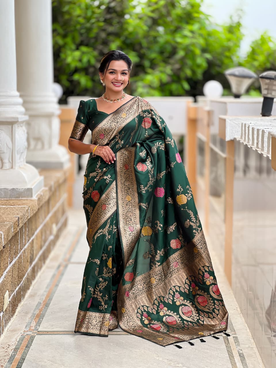 Model wearing the bottle green lotus border saree with black border