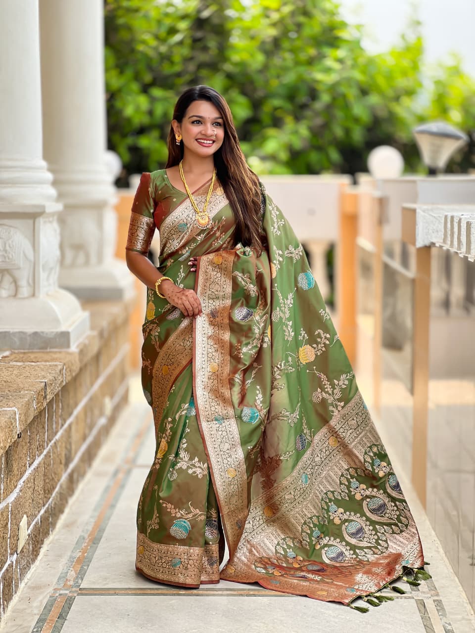 Model wearing the olive green lotus border saree with maroon border