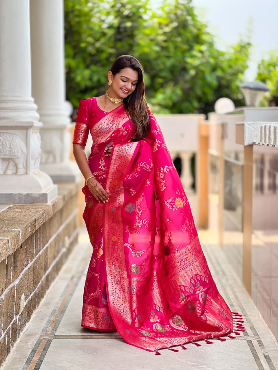Model wearing the rani pink lotus border saree
