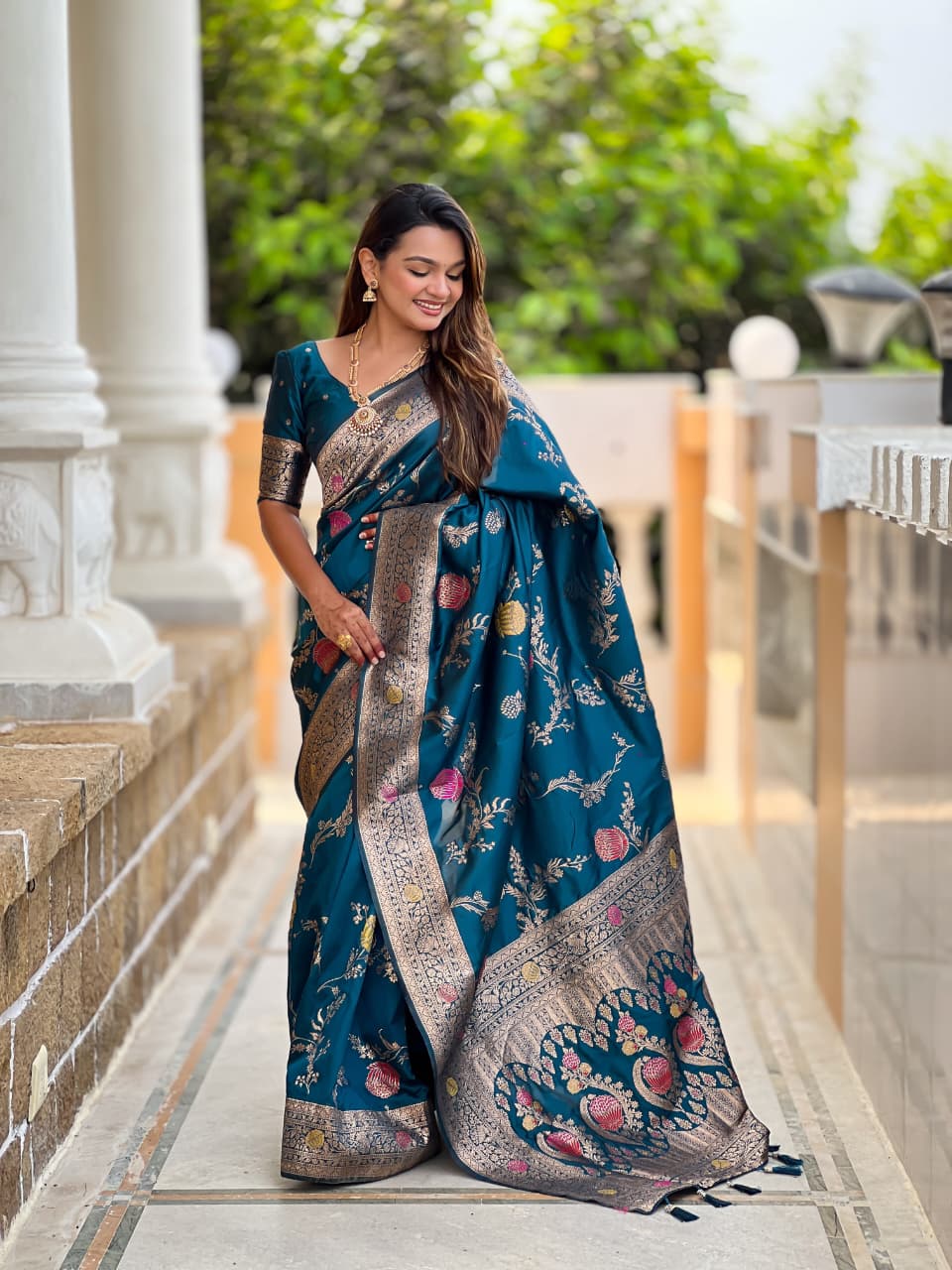 Model wearing the peacock teal lotus border saree