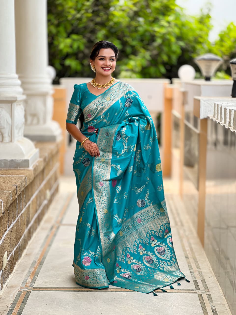Model wearing the turquoise blue lotus border saree