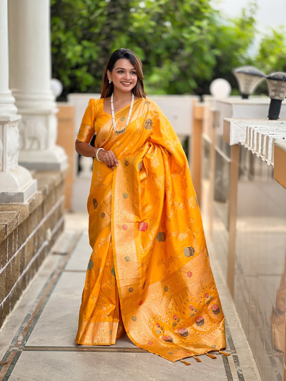 Model wearing the marigold yellow lotus border saree