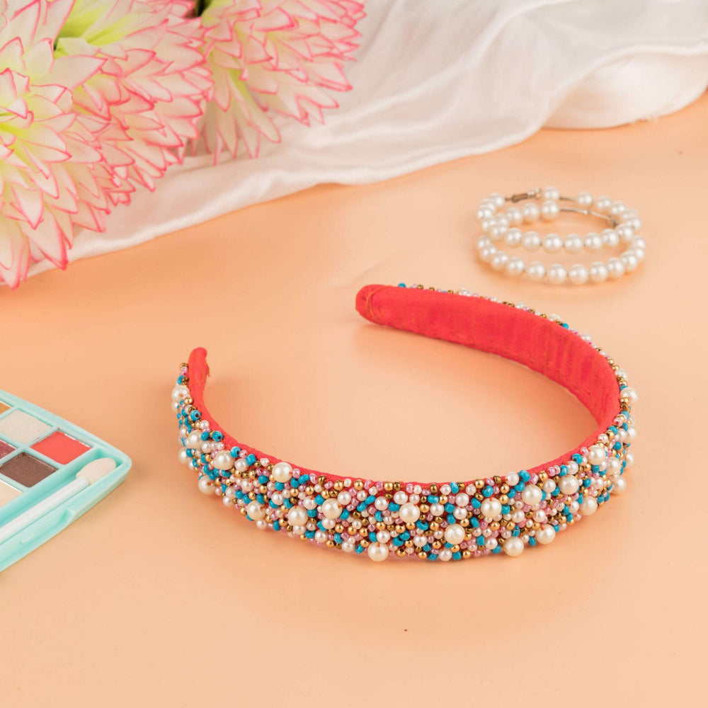 Coral headband in beaded pastel clusters styled with faux flowers and a pearl bracelet