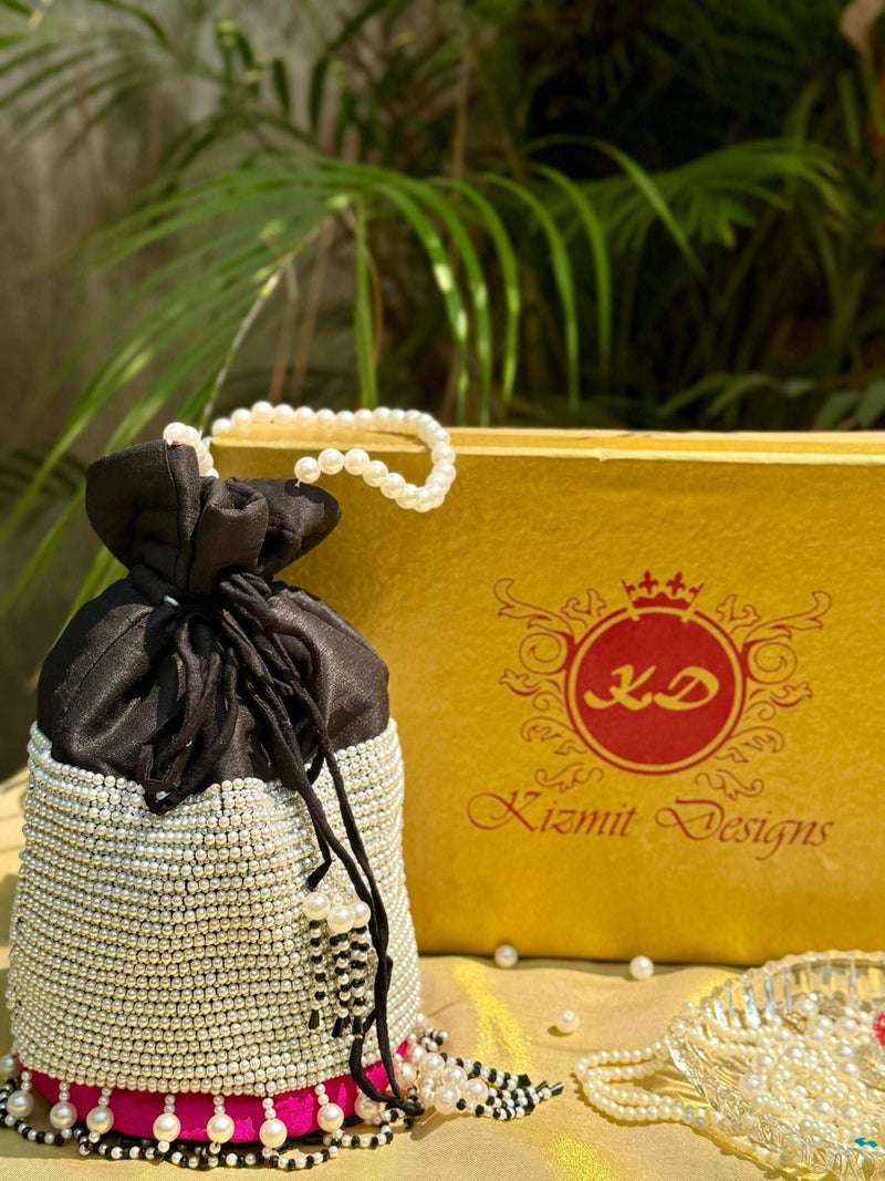 Pearl-covered potli bag with black satin top beside a gold Kizmit Designs box
