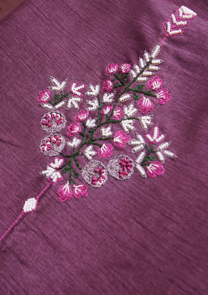 Single embroidered floral booti in pink, white and green on mauve fabric