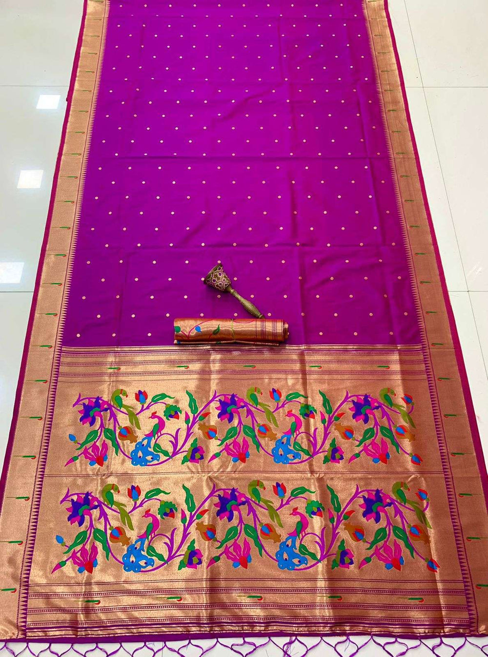 Purple Muniya Paithani saree laid out full length, gold zari pallu with floral peacock weave