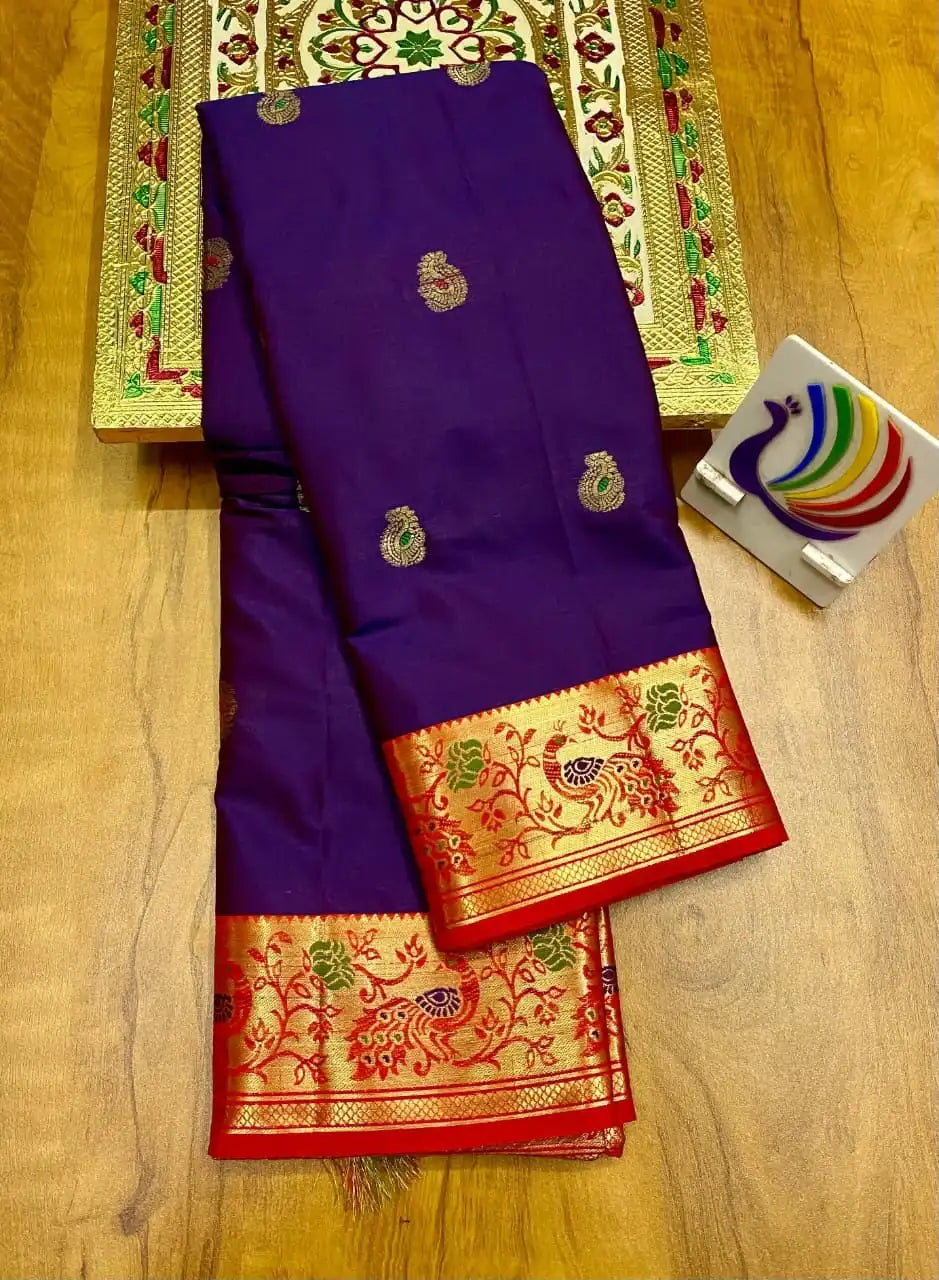 Purple Paithani saree folded to show its red and gold peacock border and zari paisley bootis